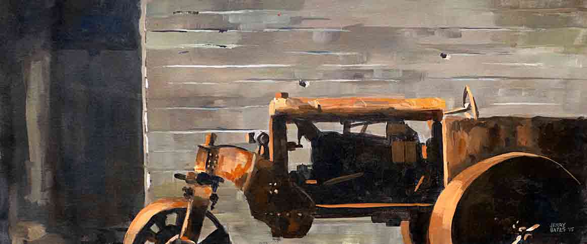 old rusty tractor against barn wall