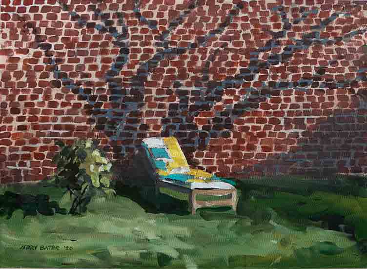 brick wall reflecting tree branches shadow with lawn chair in forground