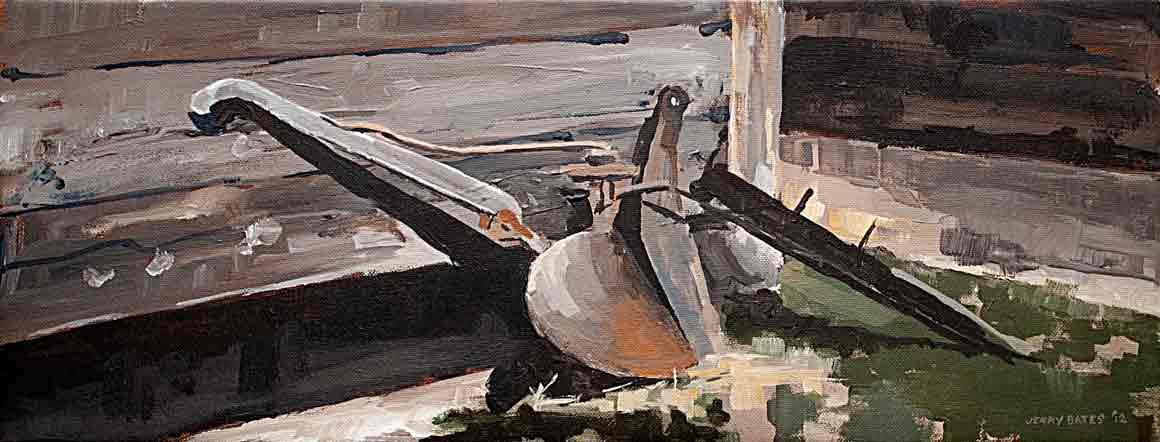 ancient old plow resting agains wall