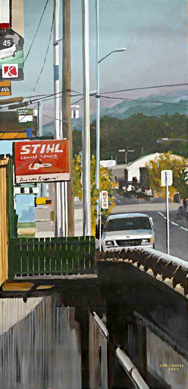 poles, lights, signage and wires looking down street