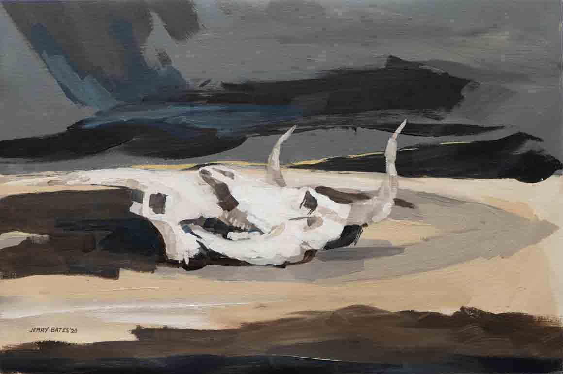two animal skulls on desert floor